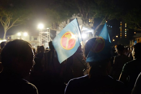 Workers' Party supporters stand in a field in Hougang, on September 2, 2015.